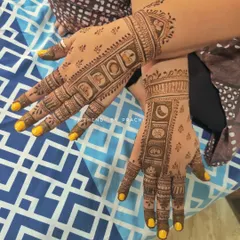 A symmetrical Karwachauth design with panels showing different elements of the festival rituals. You can see the sieve, the moon, and other traditional motifs clearly depicted on both hands.