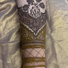 A unique cuff design on the forearm, combining floral elements with traditional band work.