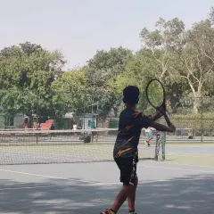 A young player prepares to hit a forehand during a competitive match at the TPL-ITA tournament. Real match experience is vital for development.