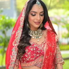 Draped in dreams. A beautiful shot of my bride in her red lehenga, with soft waves, smoky eyes, and perfectly draped dupatta.