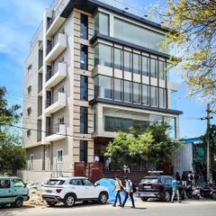 A daytime photograph capturing the building's presence on a busy street, showing how the design interacts with the urban environment.