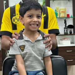Little smiles and big transformations. This young customer is clearly happy with his fresh new haircut.