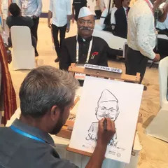 My art isn't just for weddings. Here I am sketching Member of Parliament Shri. Shrinivas Patil during the National Legislators Conference. It shows how live caricatures can be a unique and engaging feature for even the most formal corporate or government events.
