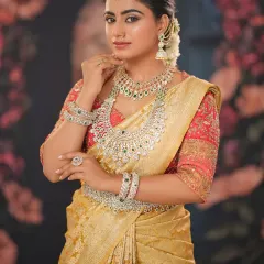 This bride is adorned with layered diamond jewelry, and the makeup is designed to complement it without being overpowering. The look is regal and sophisticated.