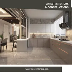 An expansive U-shaped modular kitchen with a neutral color palette and rose gold accents. The design includes a breakfast island and ample counter space, making it perfect for both cooking and socializing.