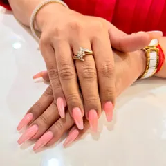 These long, coffin-shaped nails showcase a beautiful pink ombré effect. The color melts from a soft, milky base into a gentle pink, creating a subtle and feminine look that is both modern and elegant.