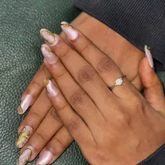 The beauty is in the details. This shot highlights the intricate application of the gold foil on each nail, giving a sophisticated and celebratory feel. Whether you want something subtle or bold, I can create the perfect set for you.