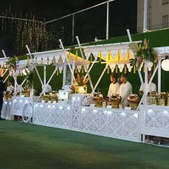 An elegant, all-white buffet setup designed to look like royal food carts. The intricate latticework and clean lines create a sophisticated and regal atmosphere for any upscale wedding or social gathering.