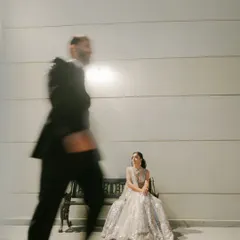 Using motion blur to create a dynamic and cinematic feel. The groom is a blur of movement while the bride remains in sharp focus, creating a compelling narrative within a single frame.