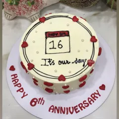 A sweet and simple way to celebrate a special date. This anniversary cake features a hand-drawn calendar marking the couple's 6th anniversary, surrounded by little red hearts.