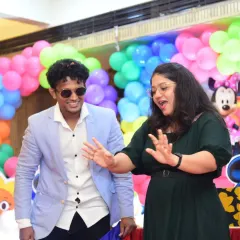 Here I am engaging a guest in a fun, interactive moment. My approach is hands-on, ensuring that people are participants in the fun, not just spectators.