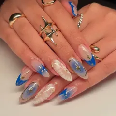 When your nails whisper secrets of the stars. This dreamy blue and white set features cosmic-inspired art with delicate star details and gold accents.