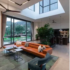 The interior of the Weekend Home at Nandi Hills, a project that has been featured for its inspiring design. The space combines comfortable, modern furniture with natural elements and stunning views, creating a perfect getaway.