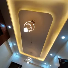 Another angle of the clean and modern false ceiling design, which provides both ambient and focused light through its cove and spotlights.