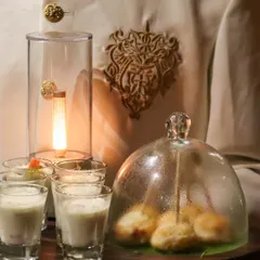 An experience in a single tray. Our server presents Dahi Golgappas under a glass cloche alongside refreshing shots, a modern and theatrical way to serve a classic.