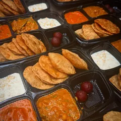 Here's a look at a bulk order of my Jain thalis, packed and ready for delivery. Each meal is sealed in a spill-proof container to keep the food fresh, warm, and neatly separated.