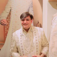 Accessorizing is key to completing any look. Here, I'm styling a Tasva sherwani with a pearl necklace and a brooch, adding a touch of royalty and glamour to the traditional ensemble. It's all about the finer details.