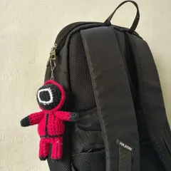 For all the Squid Game fans, this guard keychain is a must-have. Here it is attached to a backpack, showing how it can add a fun, pop-culture touch to your gear.