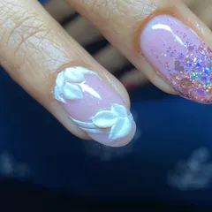 Detail of the hand-sculpted 3D white leaves on a sheer, glittery base.