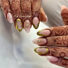 Your bridal look deserves nails that are just as special. Here, I've combined a soft, milky base with stunning 3D gold chrome frames and delicate starburst details, designed to perfectly complement traditional henna.
