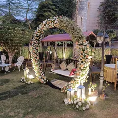 I love creating romantic settings like this for engagements or pre-wedding events. This beautiful swing, or 'jhula', is set inside a full circle arch of fresh white and peach roses, perfect for photos in a lovely garden.