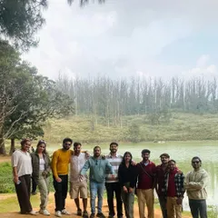 Our group by a serene lake in Ooty, enjoying the pleasant weather and beautiful scenery.