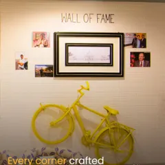 Every corner is crafted with intent. The 'Wall of Fame' and the bright yellow bicycle art piece are examples of how I use thematic decor to tell a story and make a space memorable and Instagram-worthy.