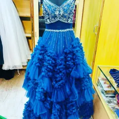 This royal blue gown with a ruffled skirt and a silver-sequined bodice is designed for making an entrance. It's a perfect choice for a glamorous cocktail night or reception party.