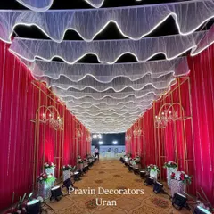 I believe the guest's experience begins at the entrance. Here, we created a dramatic entrance tunnel with flowing red drapes, illuminated white fabric on the ceiling, and elegant chandeliers to build excitement from the very first step.