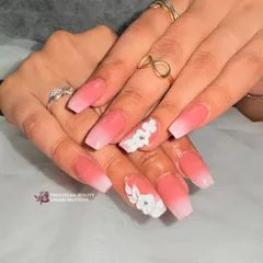 A beautiful example of ombre meeting 3D art. I blended a soft pink to white base on coffin nails and then sculpted delicate white flowers on top for a feminine and dimensional look.