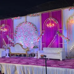 This stage combines modern and classic elements with a purple and white color scheme. I used geometric gold frames, hanging chandeliers, and a circular floral arrangement to create a unique and stylish focal point.