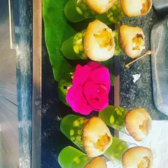 A modern twist on a classic favorite: Gol Gappe Shots. Each puri is served atop a shot glass filled with tangy, spiced water, making it a fun and mess-free way for guests to enjoy this iconic street food.