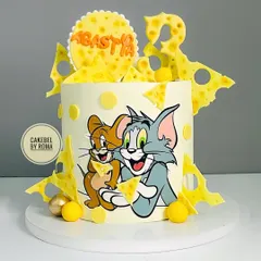 A cake celebrating the timeless friendship and mischief of Tom and Jerry. I used edible prints for the characters and surrounded them with fun, cheesy details for Agastya's 3rd birthday.
