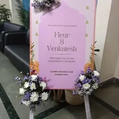 A personalized welcome sign for Fleur and Venkatesh's engagement ceremony. The sign is decorated with beautiful fresh flower arrangements to greet guests as they arrive.