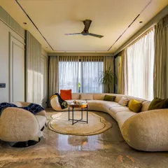 A glimpse into a drawing room designed to let the light in. Bathed in a neutral palette with a curved sofa, this room is all about softness and ease, encouraging long conversations and unhurried afternoons.