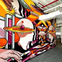A wide-angle shot of the first mural, designed for the global customer support team. It revolves around themes of empathy and human-centered service, visualized through a surreal, cosmic landscape.
