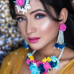 A close-up of the vibrant Haldi makeup. You can see the detailed eyeshadow blending and the luminous highlighter that makes her skin glow, perfect for a daytime event.
