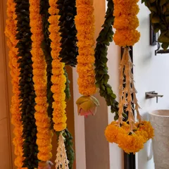 There's something so special about traditional housewarming decor. Here, I've used classic genda phool (marigold) garlands with delicate jasmine tassels to create a warm and auspicious welcome for a new beginning.