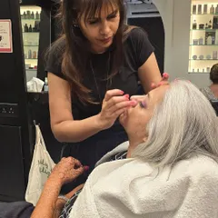 The process of creating this bridal cocktail magic. Here, I am carefully applying eye makeup to enhance her features.