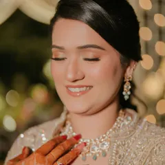 A close-up of the sangeet glam. You can see the soft shimmer on the eyes and the glossy nude lip, a perfect combination for a modern look.