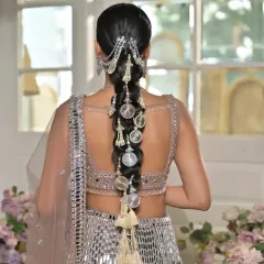 This is a modern take on a traditional bridal braid, crafted for a jewellery brand campaign. I used intricate silver hair accessories and charms to match the mirror-work lehenga, resulting in a contemporary and cohesive look.