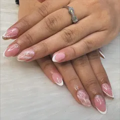 A modern twist on a timeless classic. This look combines a clean French manicure with delicate marble art and a hint of gold glitter for an elegant and sophisticated finish.
