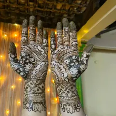 A beautiful example of a full palm design with negative space that makes the floral and paisley patterns pop. The wrist cuff features tiny elephant motifs for a traditional touch.