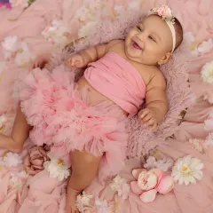 The giggles and chubby rolls of a four-month-old are just the best. This milestone session is all about capturing your baby's budding personality and infectious laughter in a beautiful, fun setup.
