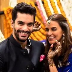 The happy couple, Neha Dhupia and Angad Bedi, showing off the simple, elegant mehandi we designed for their intimate wedding.