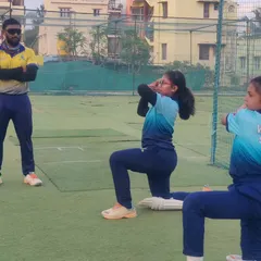 Our "Cricket Queen Warriors" in action. This image shows the focus and discipline of our U-12 girls during a fitness drill, with a coach supervising their form.