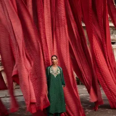 For this Anita Dongre campaign, I wanted to create a powerful visual ode to Indian craftsmanship. Here, a model stands in an emerald green ensemble against a backdrop of vibrant red Bandhani textiles, creating a striking contrast that celebrates the beauty of traditional tie-dye techniques from Rajasthan.