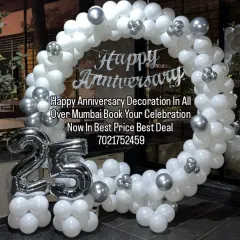 For a classic and elegant 25th silver jubilee, we created this full circular balloon arch using white and silver balloons. The design includes a custom "Happy Anniversary" sign and large silver foil balloons for the number '25', making it a grand centerpiece for the party.