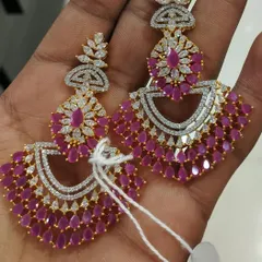 For those who love sparkle, these American Diamond chandbalis are a perfect choice. The fine cutting of the stones gives them a brilliant shine, and the ruby-colored drops add a touch of vibrant color, making them ideal for evening parties.