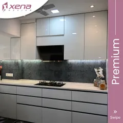 This premium kitchen design uses a sophisticated palette of light grey and a dark patterned backsplash. The handle-less drawers and cabinets create a clean, uninterrupted look, which is a hallmark of modern kitchen interiors.